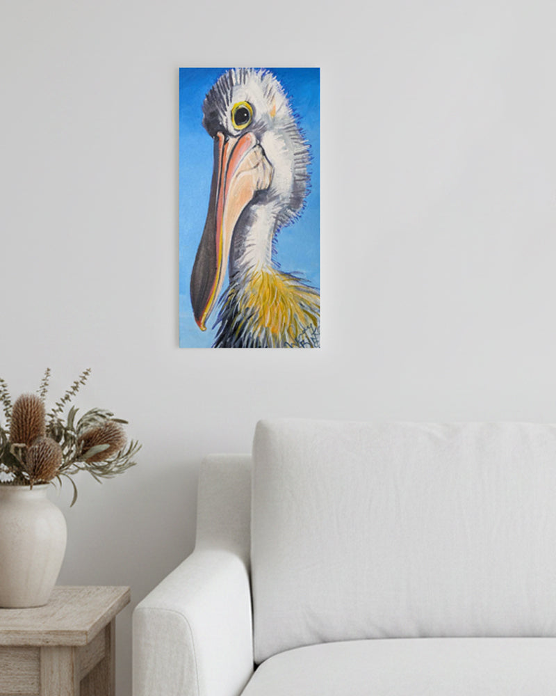 Canvas print of a pelican on a wall above a sofa