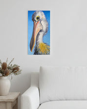 Canvas print of a pelican on a wall above a sofa